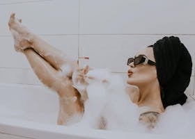 Woman in Bathtub Holding Wineglass